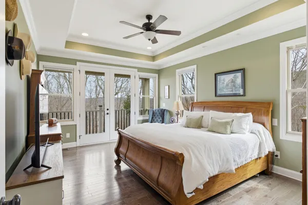 a bedroom with a large bed and a chandelier