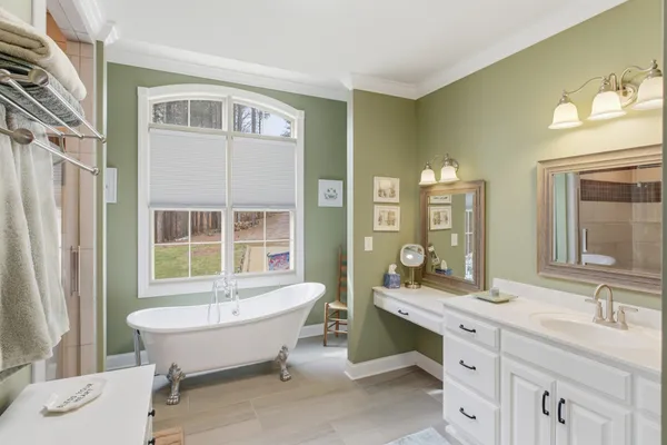 a bathroom with a bathtub sink and mirror