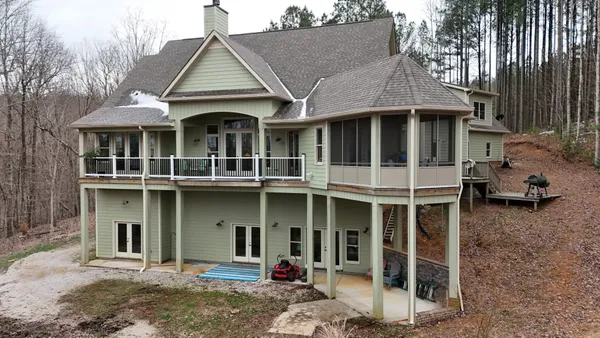 a front view of a house with a yard and seating space