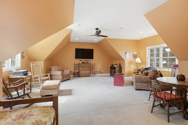 a dining room with furniture and floor to ceiling window