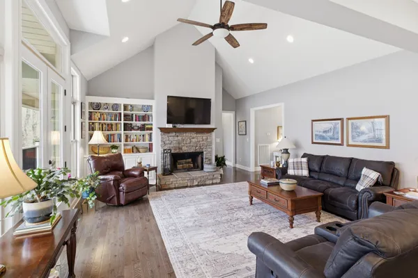 a living room with furniture a fireplace and a flat screen tv