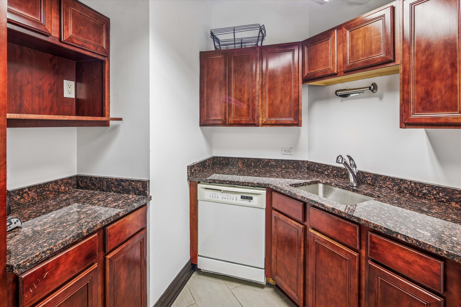 1327 West Washington Boulevard, Unit 105 Chicago, IL 60607 - Photo 13 of 16 a kitchen with granite countertop stainless steel appliances sink stove and cabinets