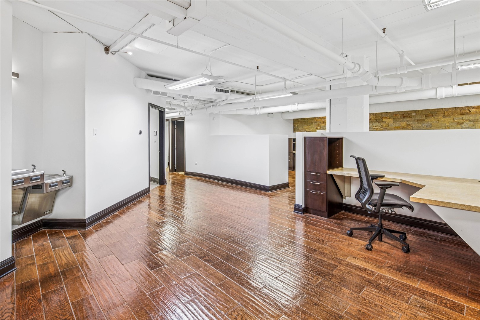 1327 West Washington Boulevard, Unit 105 Chicago, IL 60607 - Photo 16 of 16 a view of a room with wooden floor and furniture