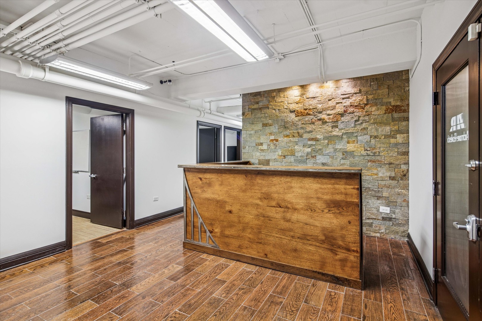 1327 West Washington Boulevard, Unit 105 Chicago, IL 60607 - Photo 3 of 16 a view of a room with wooden floor and large window