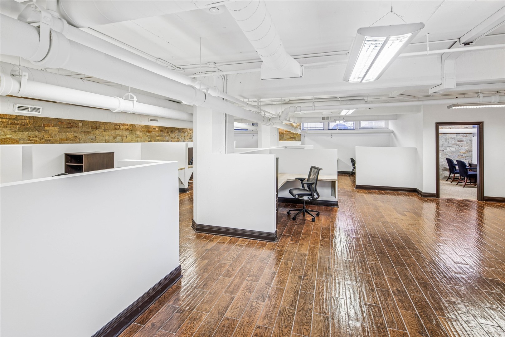 1327 West Washington Boulevard, Unit 105 Chicago, IL 60607 - Photo 8 of 16 a view of a room with wooden floor and furniture