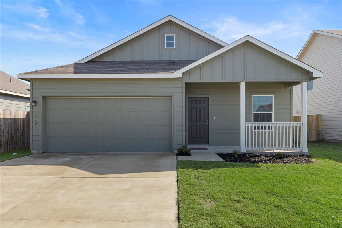 14320 Tordillo Drive Elgin, TX 78621 - Photo 1 of 19 View of front of property featuring roof with shingles, covered porch, board and batten siding, driveway, and an attached garage