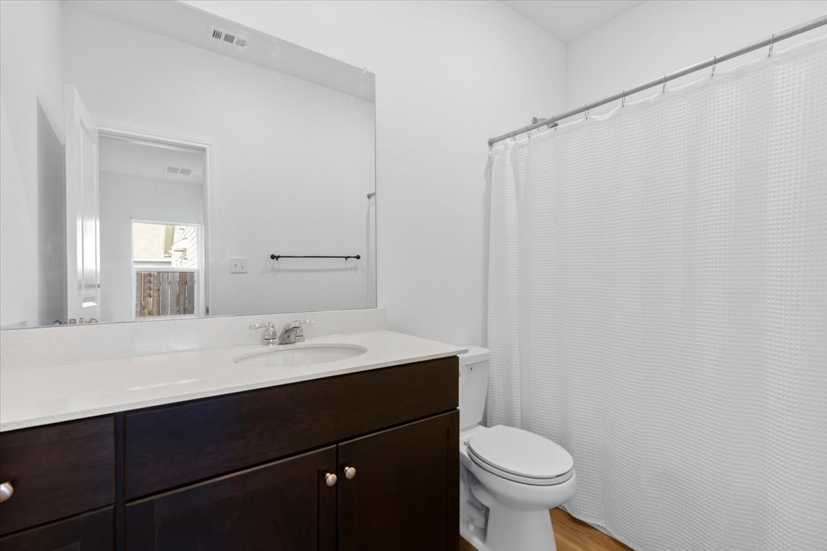 14320 Tordillo Drive Elgin, TX 78621 - Photo 13 of 19 Full bath featuring curtained shower, vanity, and light wood finished floors