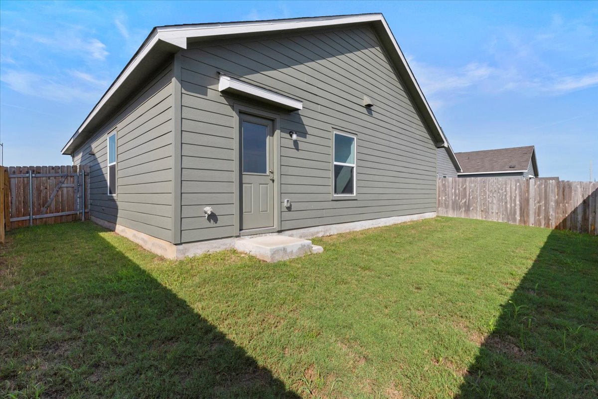 14320 Tordillo Drive Elgin, TX 78621 - Photo 17 of 19 Rear view of property featuring a fenced backyard