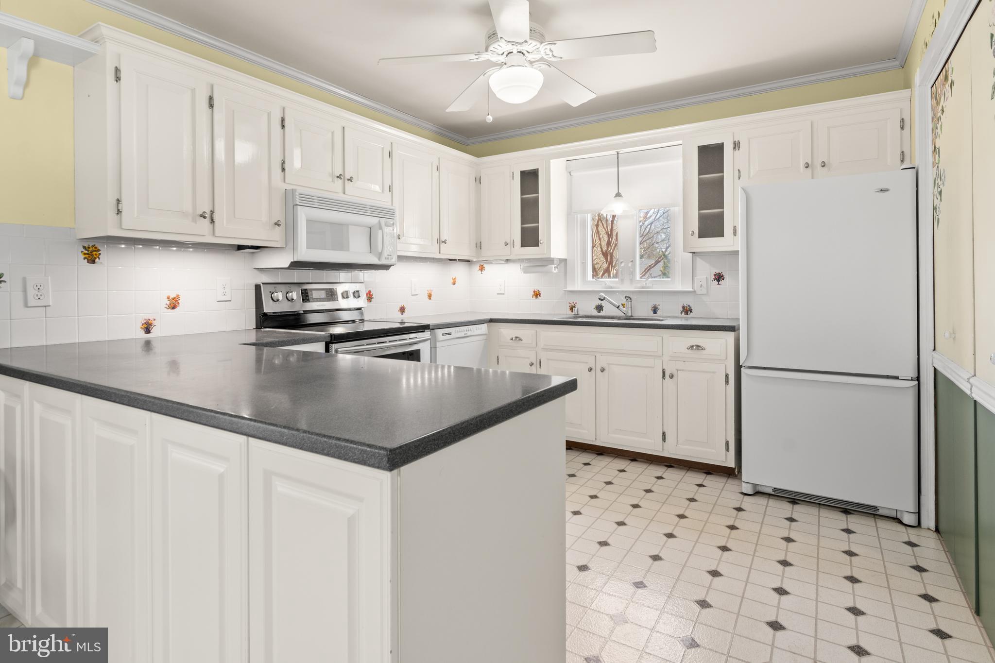22539 Indian Point Road Bozman, MD 21612 - Photo 16 of 66 a kitchen with granite countertop a sink cabinets stainless steel appliances and a counter space