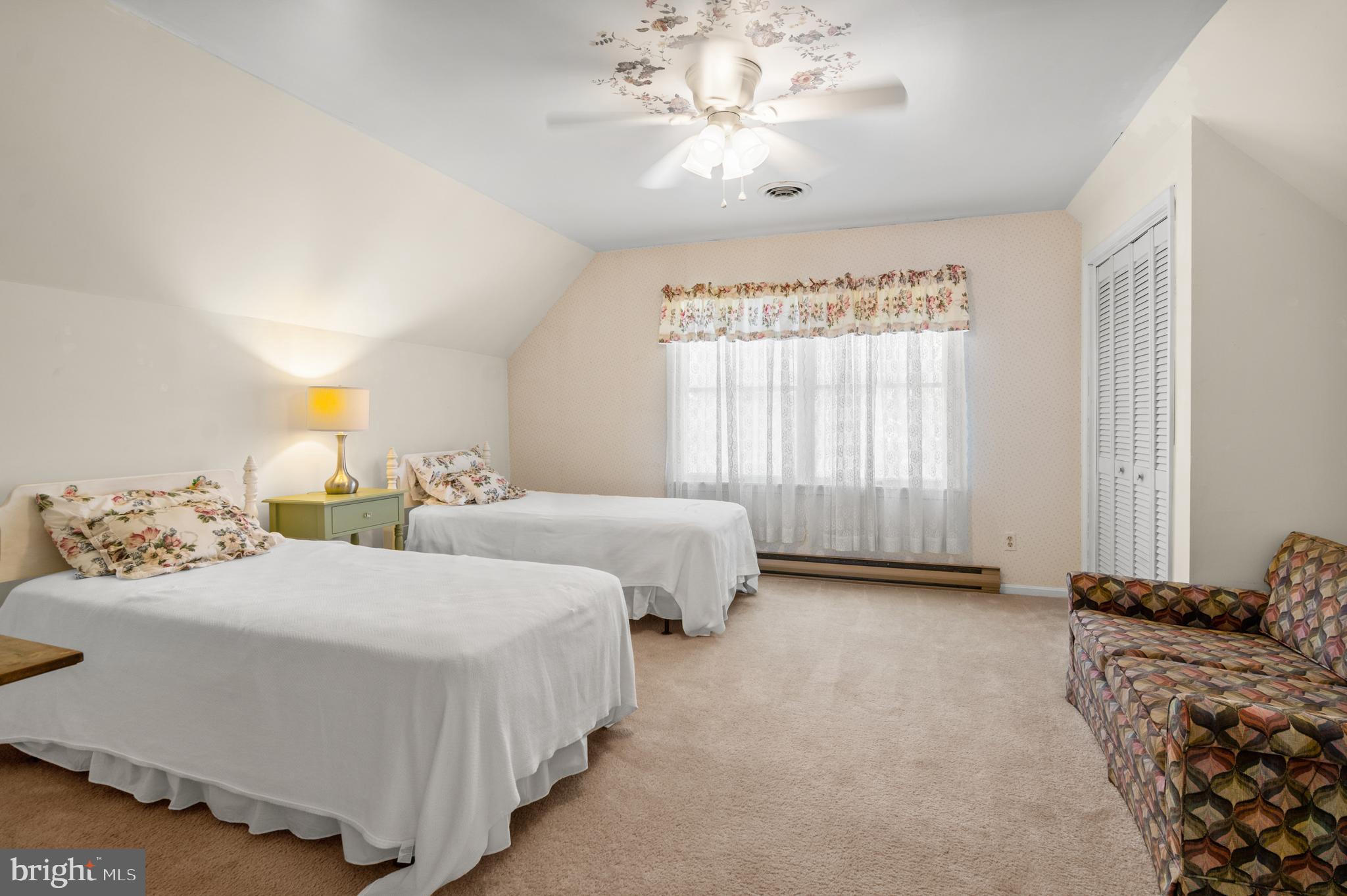 22539 Indian Point Road Bozman, MD 21612 - Photo 28 of 66 a spacious bedroom with two beds and a chandelier