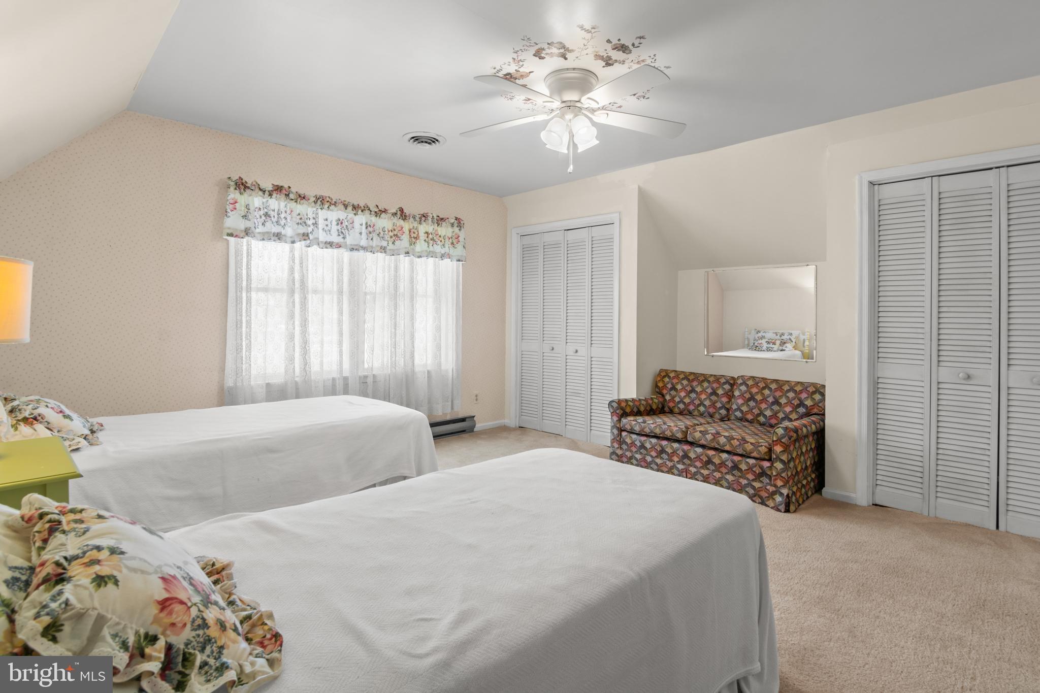 22539 Indian Point Road Bozman, MD 21612 - Photo 30 of 66 a bedroom with two beds and a chandelier