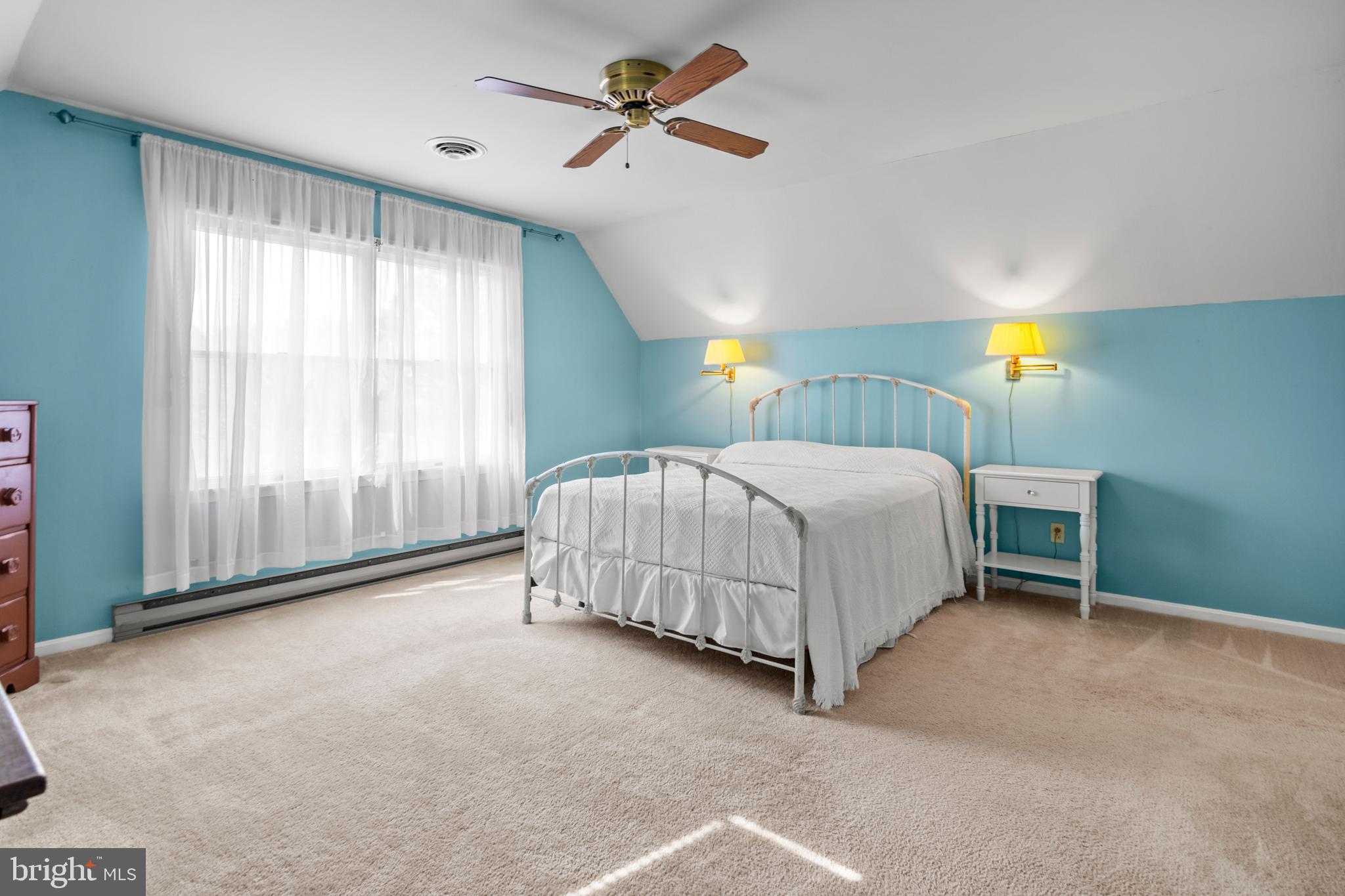 22539 Indian Point Road Bozman, MD 21612 - Photo 35 of 66 a bedroom with a bed and a chandelier