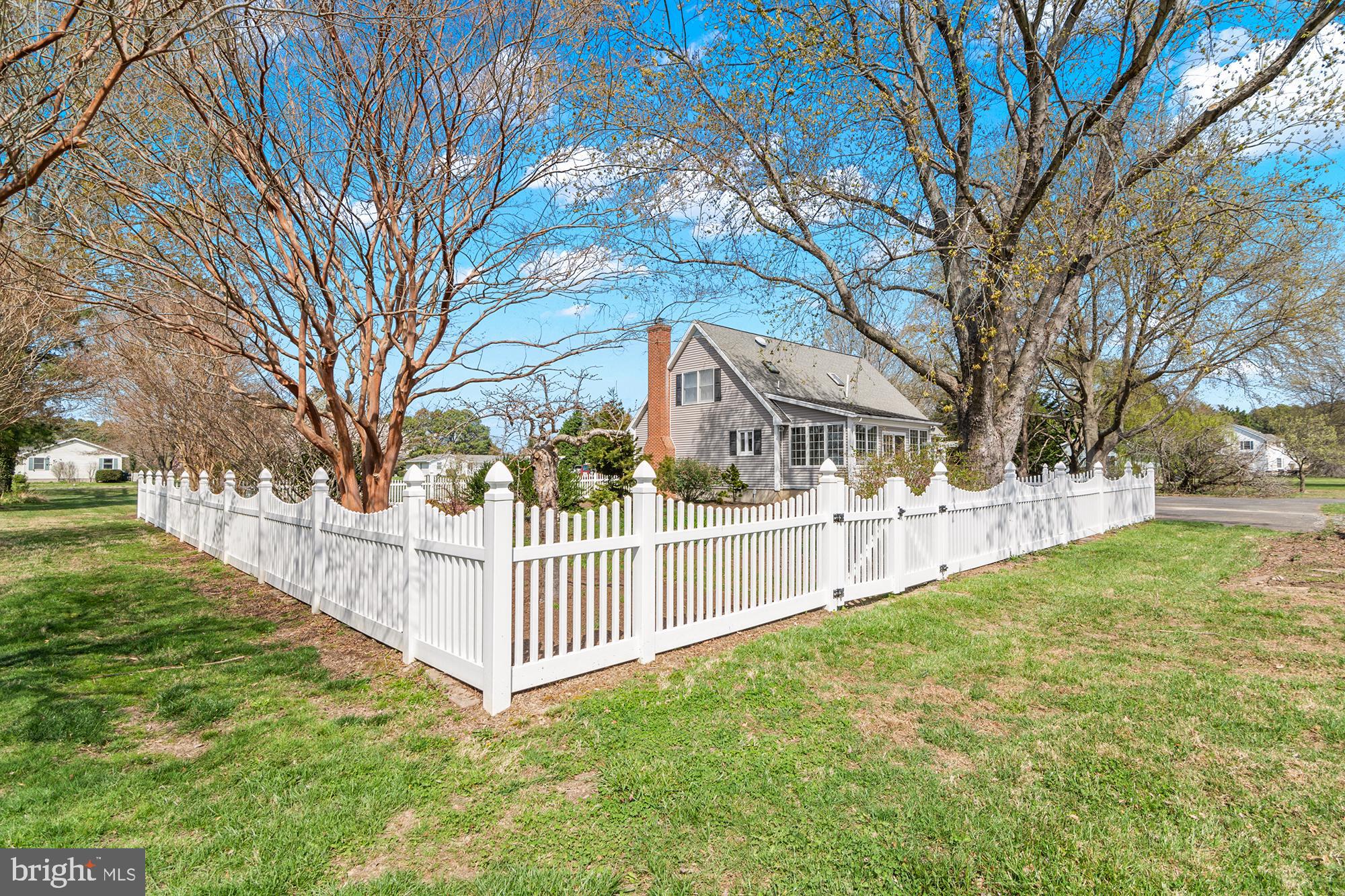 22539 Indian Point Road Bozman, MD 21612 - Photo 44 of 66 a view of a yard with large trees and wooden fence