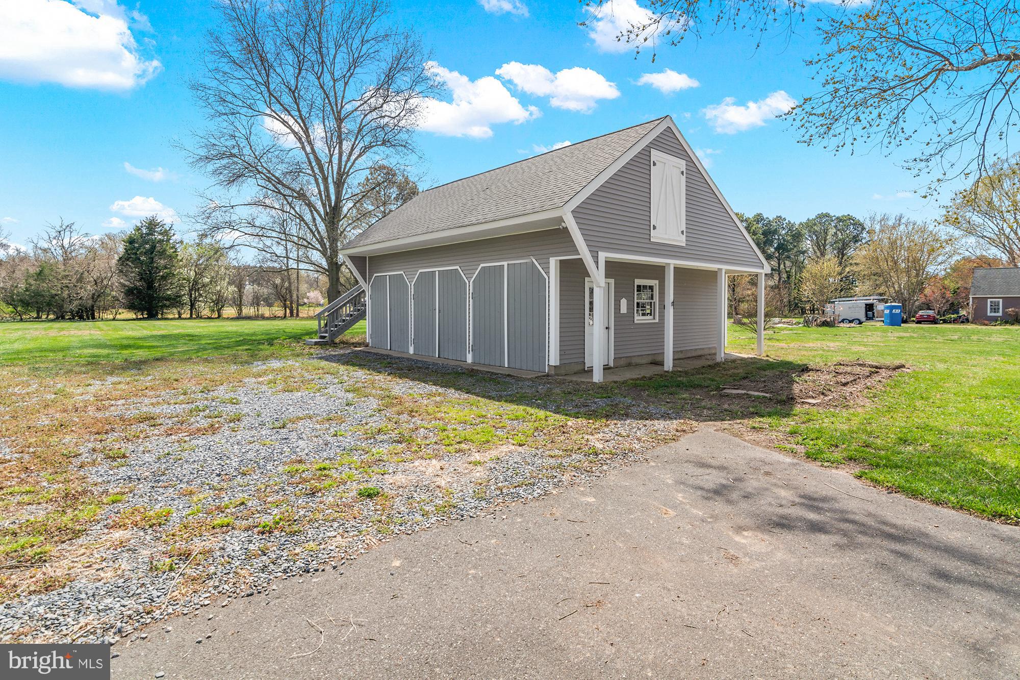 22539 Indian Point Road Bozman, MD 21612 - Photo 48 of 66 a front view of house with yard and trees all around