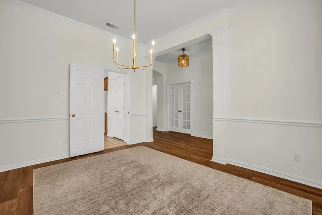 a view of empty room with wooden floor and fireplace