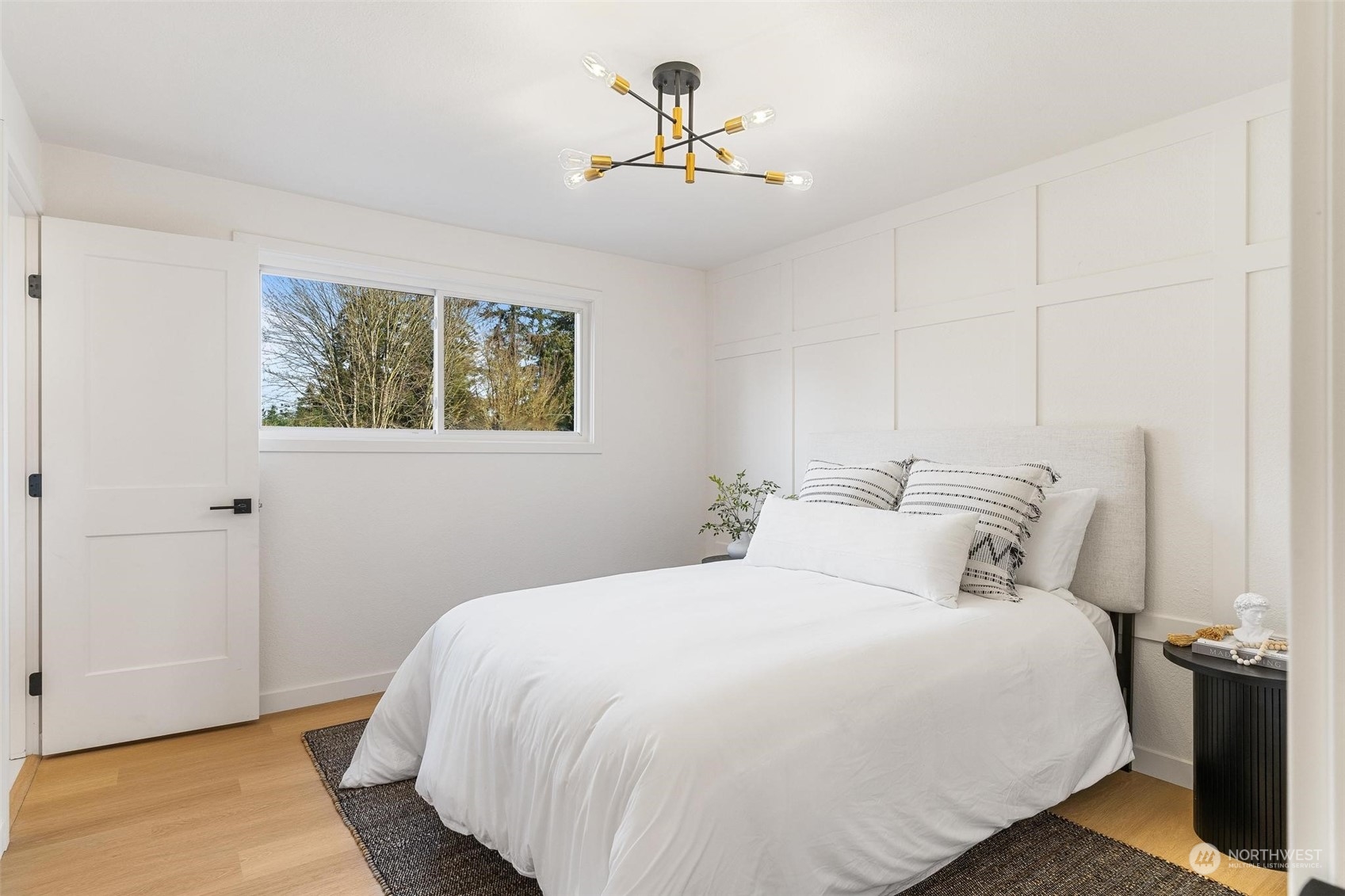 302 225th Street Southwest Bothell, WA 98021 - Photo 18 of 39 a bedroom with a bed and a chandelier