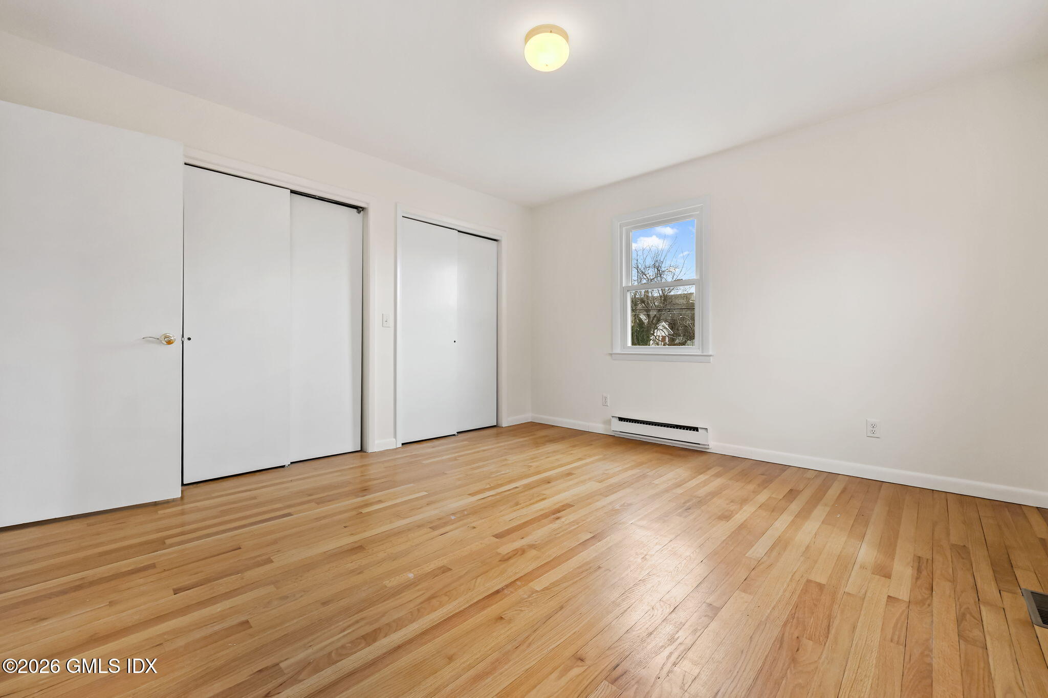 2 Grange Street Greenwich, CT 06830 - Photo 10 of 31 an empty room with wooden floor and windows