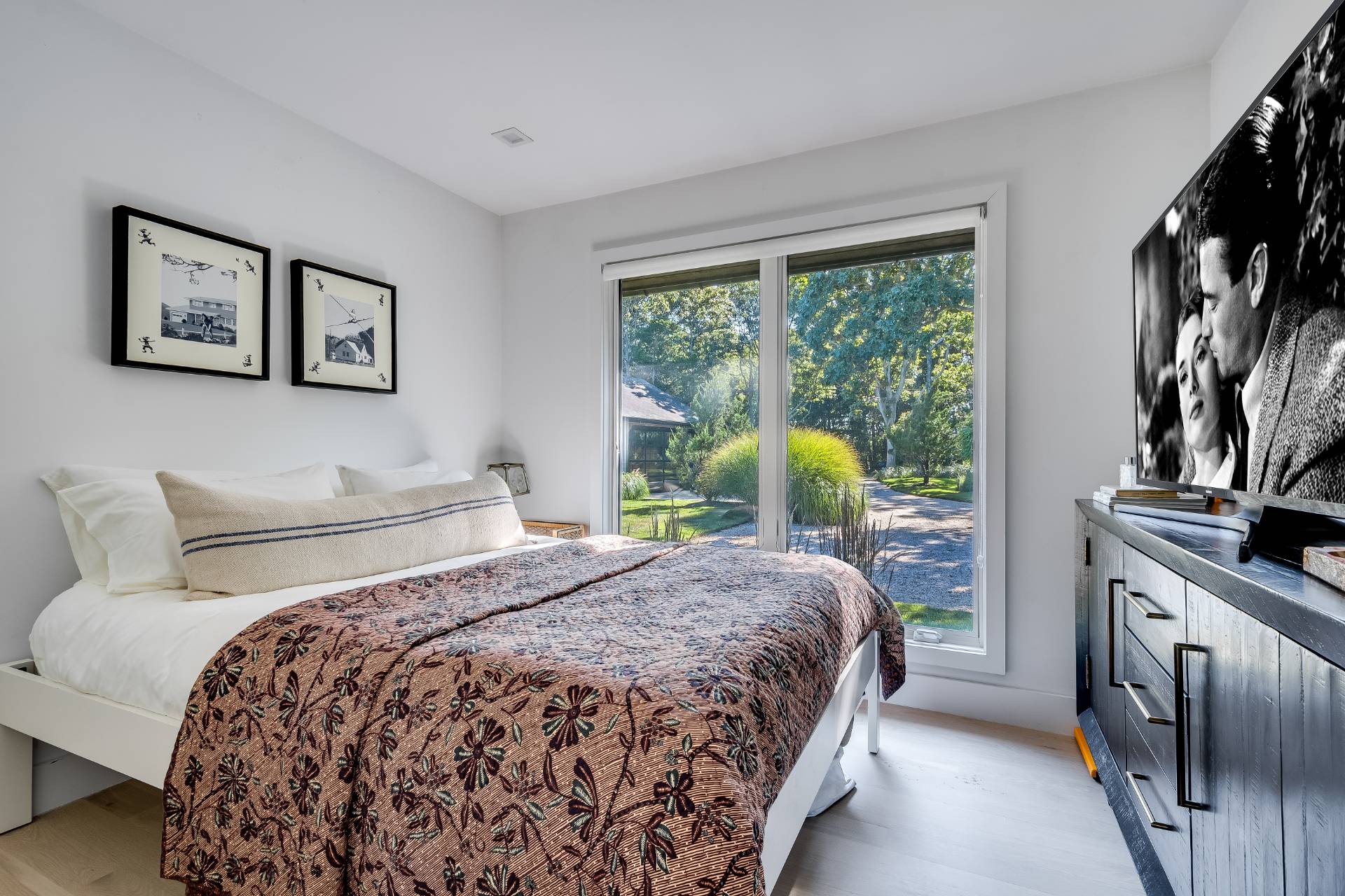 101 Gerard Drive East Hampton, NY 11937 - Photo 16 of 29 a bedroom with a bed next to a window with outer view