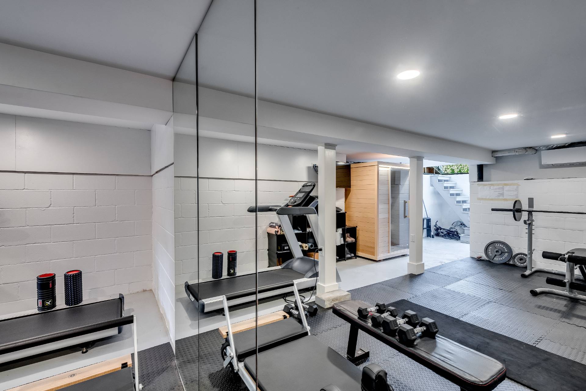 101 Gerard Drive East Hampton, NY 11937 - Photo 17 of 29 a room with gym equipment and a view of living room