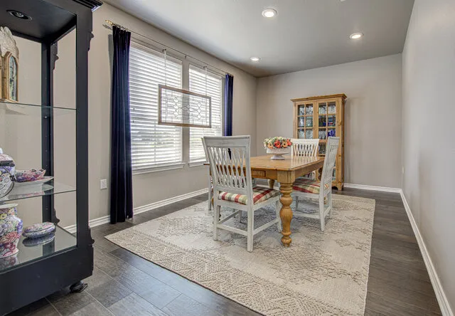 a dining room with furniture and window
