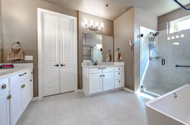 a view of a bathroom with a sink mirror and a bathtub
