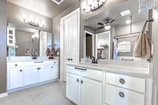 a bathroom with a double vanity sink mirror and