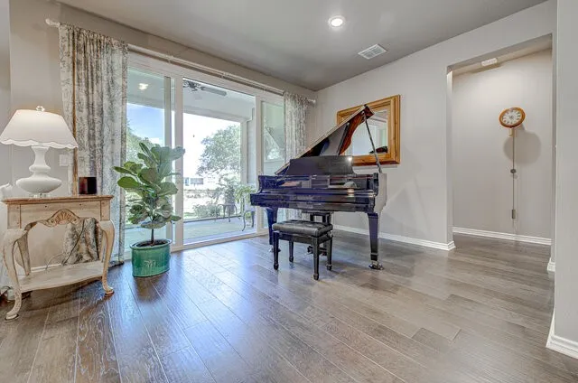 a living room with furniture and wooden floor