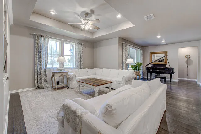 a living room with furniture and wooden floor
