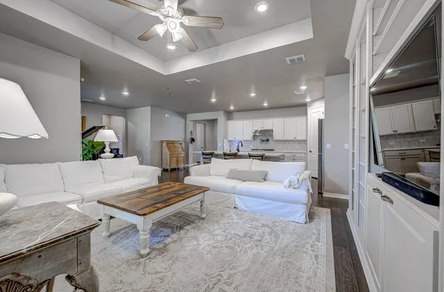 a living room with furniture and kitchen view