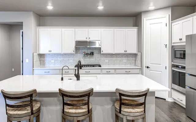 a kitchen with stainless steel appliances a sink and a stove top oven