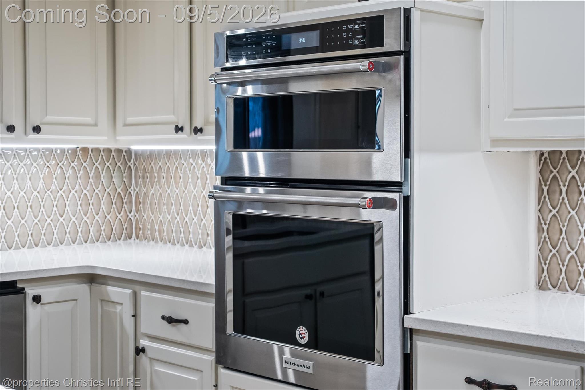 1540 Mill Race Road Rochester, MI 48306 - Photo 18 of 99 Stainless steel dual wall oven with convection capability and integrated microwave, paired with soft-close cabinetry and geometric tile backsplash