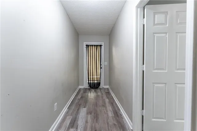 a view of a room with wooden floor