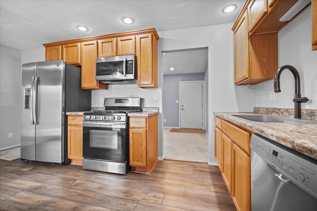 1303 Dalton Drive Normal, IL 61761 - Photo 10 of 20 a kitchen with stainless steel appliances granite countertop a stove a sink and a refrigerator