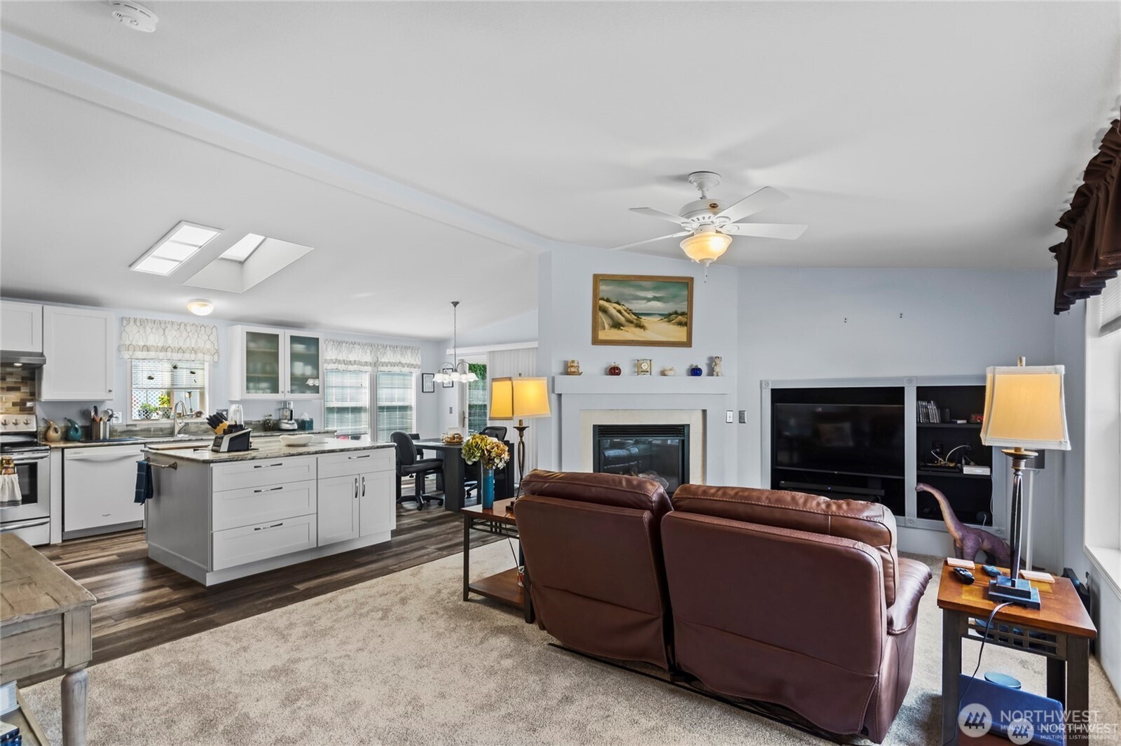 6719 241st Avenue East, Unit 46 Buckley, WA 98321 - Photo 11 of 35 a living room with furniture a fireplace and a flat screen tv
