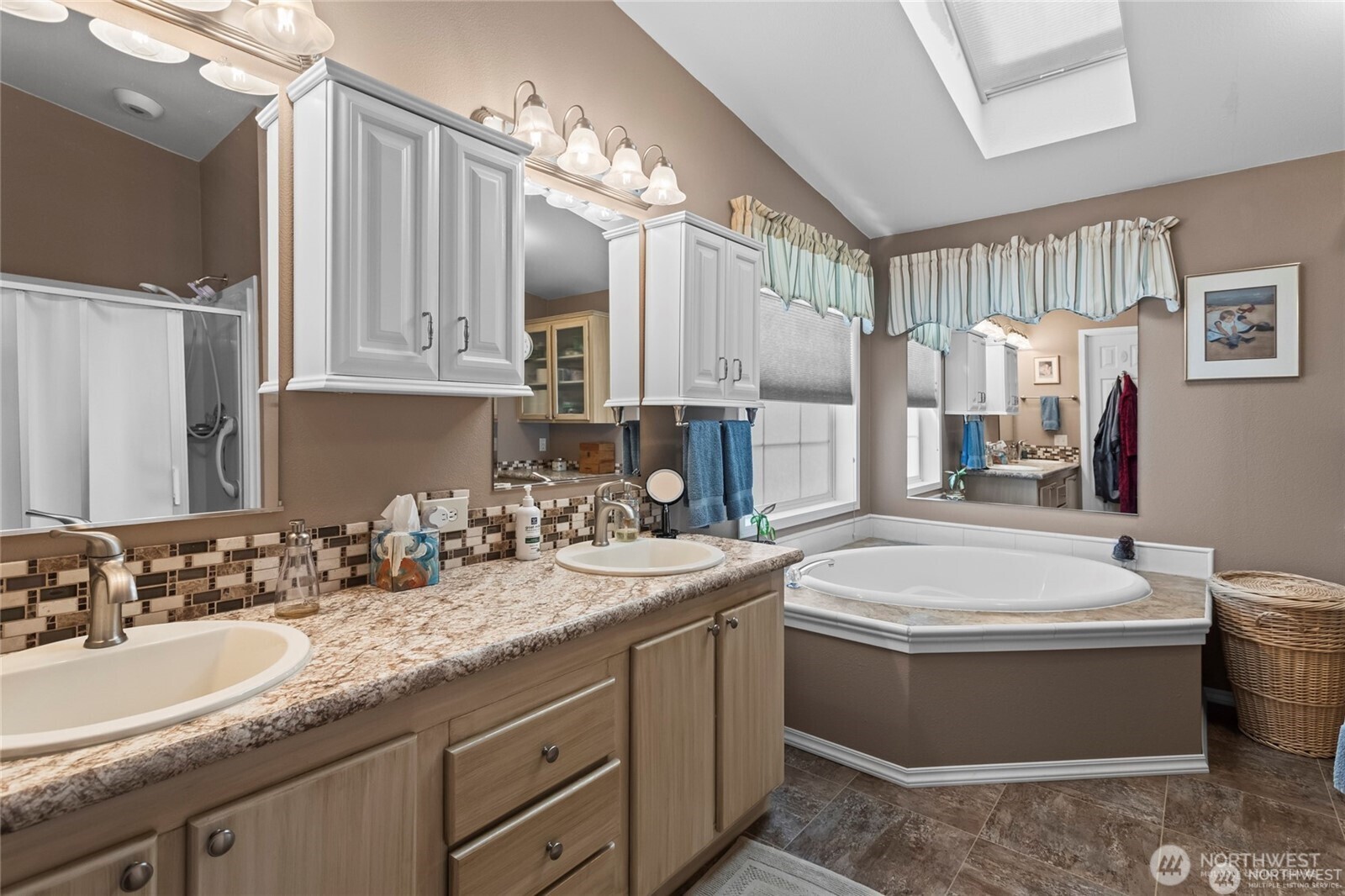 6719 241st Avenue East, Unit 46 Buckley, WA 98321 - Photo 22 of 35 a bathroom with a double vanity sink a mirror a toilet and a bathtub