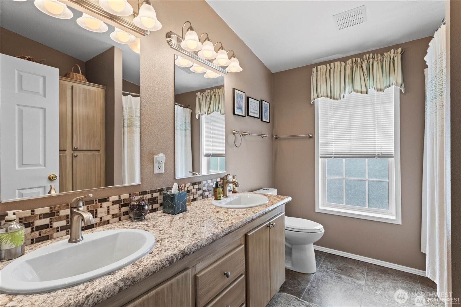6719 241st Avenue East, Unit 46 Buckley, WA 98321 - Photo 23 of 35 a bathroom with a granite countertop double vanity sink mirror and toilet