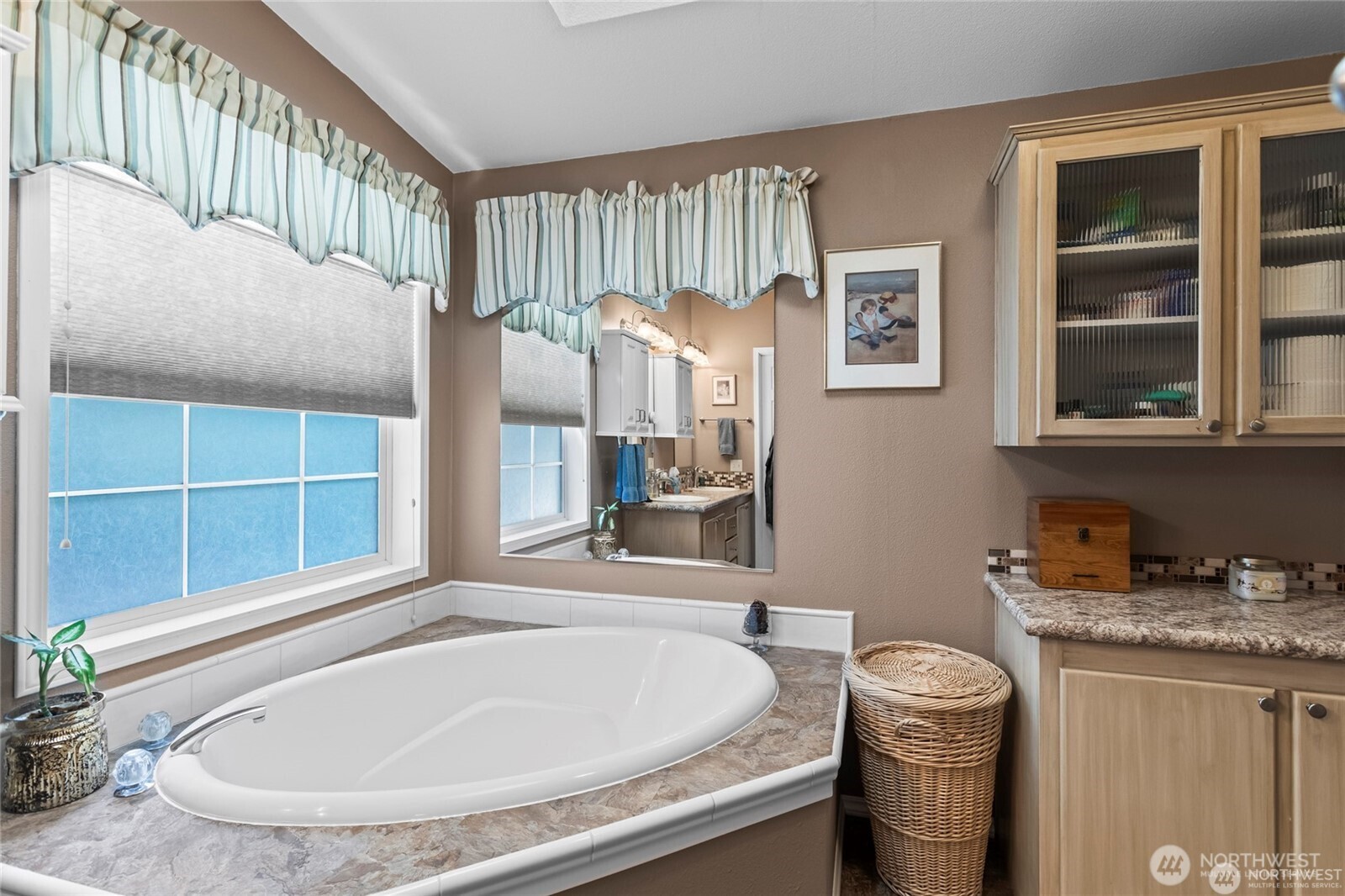 6719 241st Avenue East, Unit 46 Buckley, WA 98321 - Photo 24 of 35 a bathroom with a granite countertop sink and a mirror