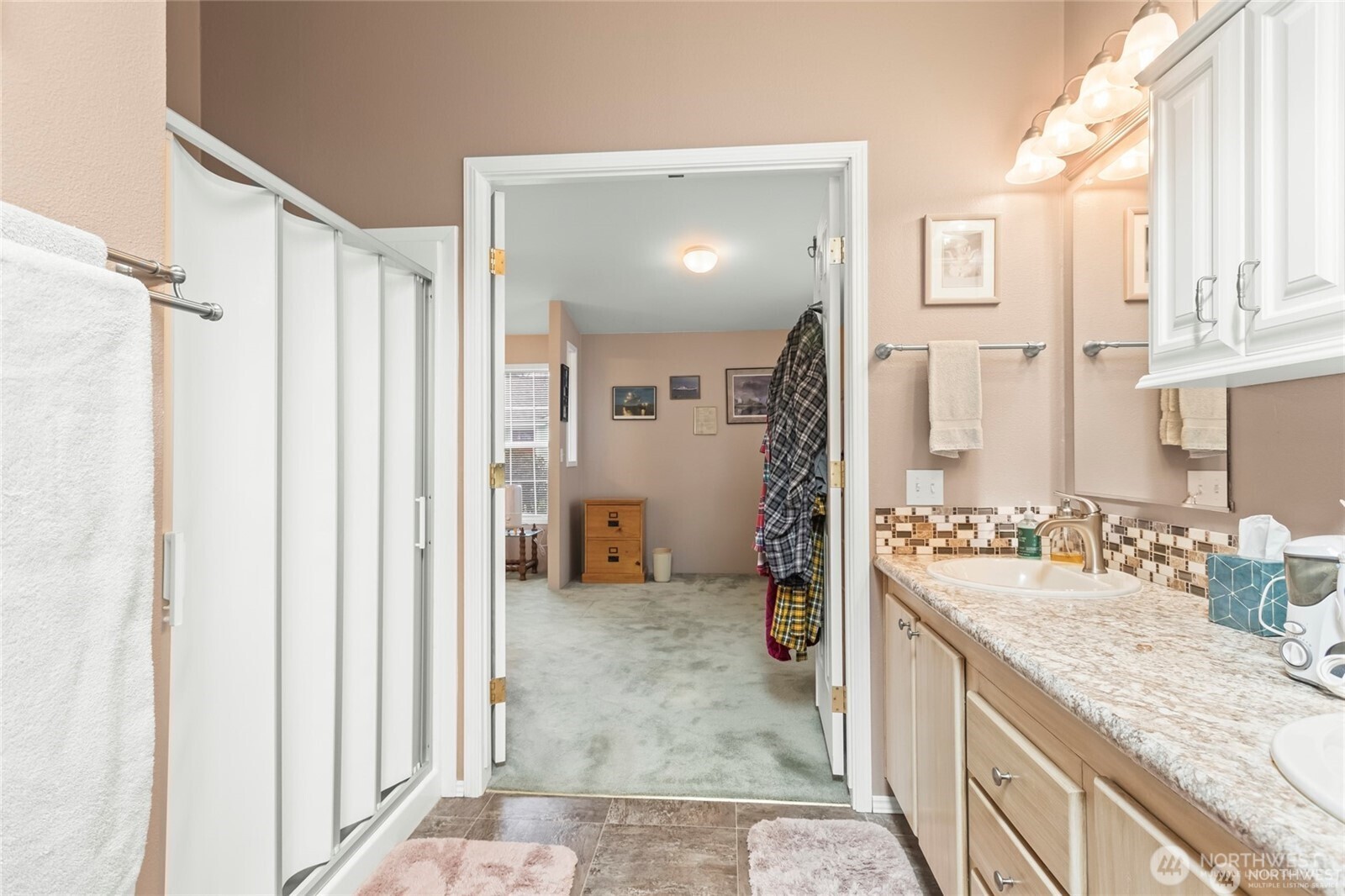 6719 241st Avenue East, Unit 46 Buckley, WA 98321 - Photo 25 of 35 a bathroom with a granite countertop sink a mirror and a shower