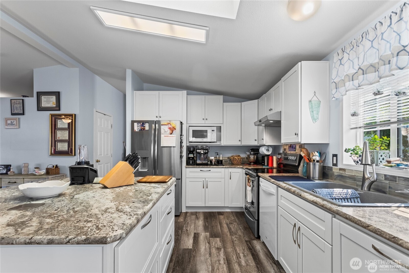 6719 241st Avenue East, Unit 46 Buckley, WA 98321 - Photo 3 of 35 a kitchen with granite countertop a sink stove and refrigerator