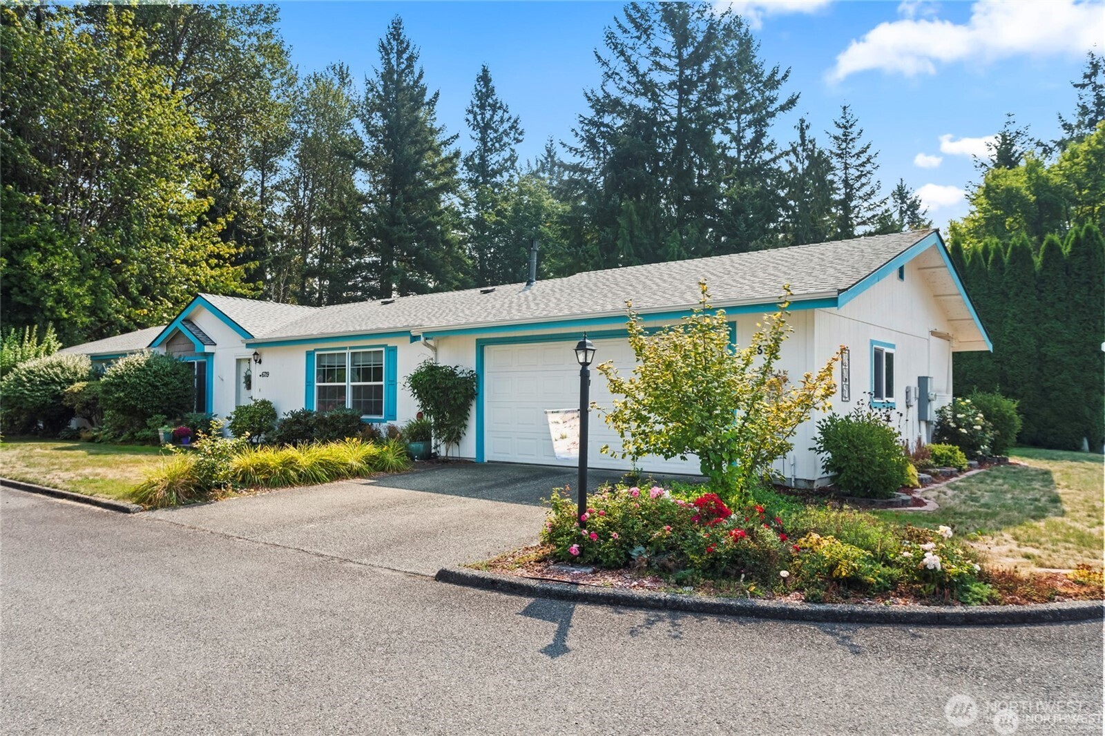 6719 241st Avenue East, Unit 46 Buckley, WA 98321 - Photo 32 of 35 a front view of a house with a yard and outdoor seating