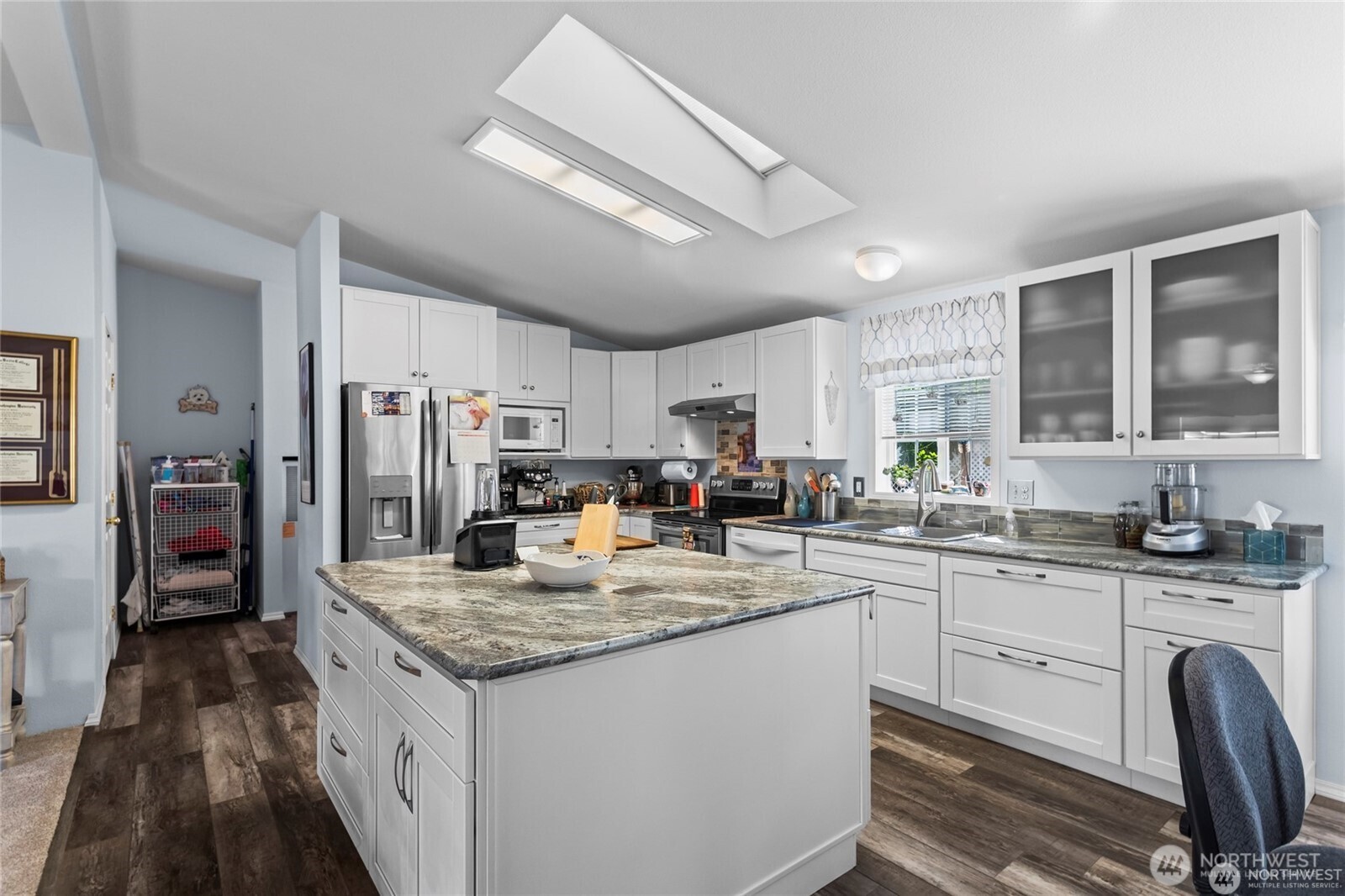 6719 241st Avenue East, Unit 46 Buckley, WA 98321 - Photo 4 of 35 a kitchen with granite countertop a sink stove refrigerator and cabinets