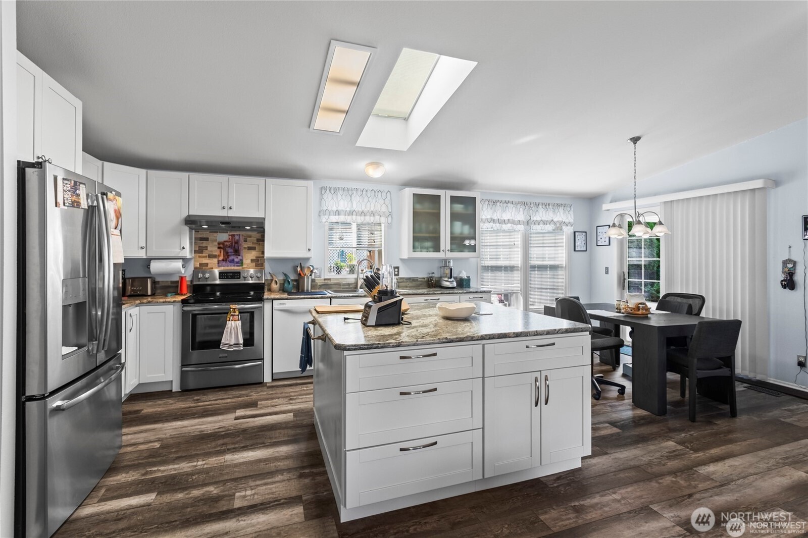 6719 241st Avenue East, Unit 46 Buckley, WA 98321 - Photo 6 of 35 a kitchen with a sink stainless steel appliances and cabinets