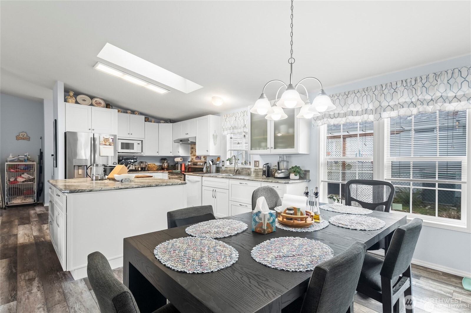 6719 241st Avenue East, Unit 46 Buckley, WA 98321 - Photo 7 of 35 a dining room with granite countertop wooden floor a table and chairs
