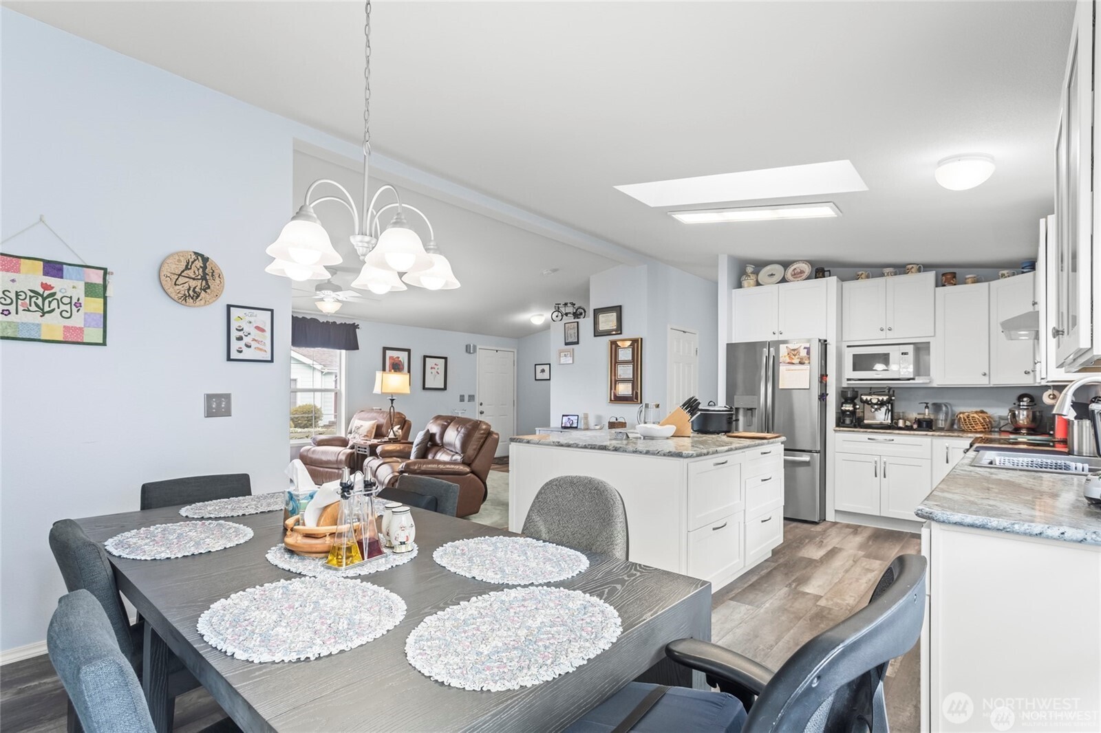 6719 241st Avenue East, Unit 46 Buckley, WA 98321 - Photo 8 of 35 a kitchen with a dining table and chairs