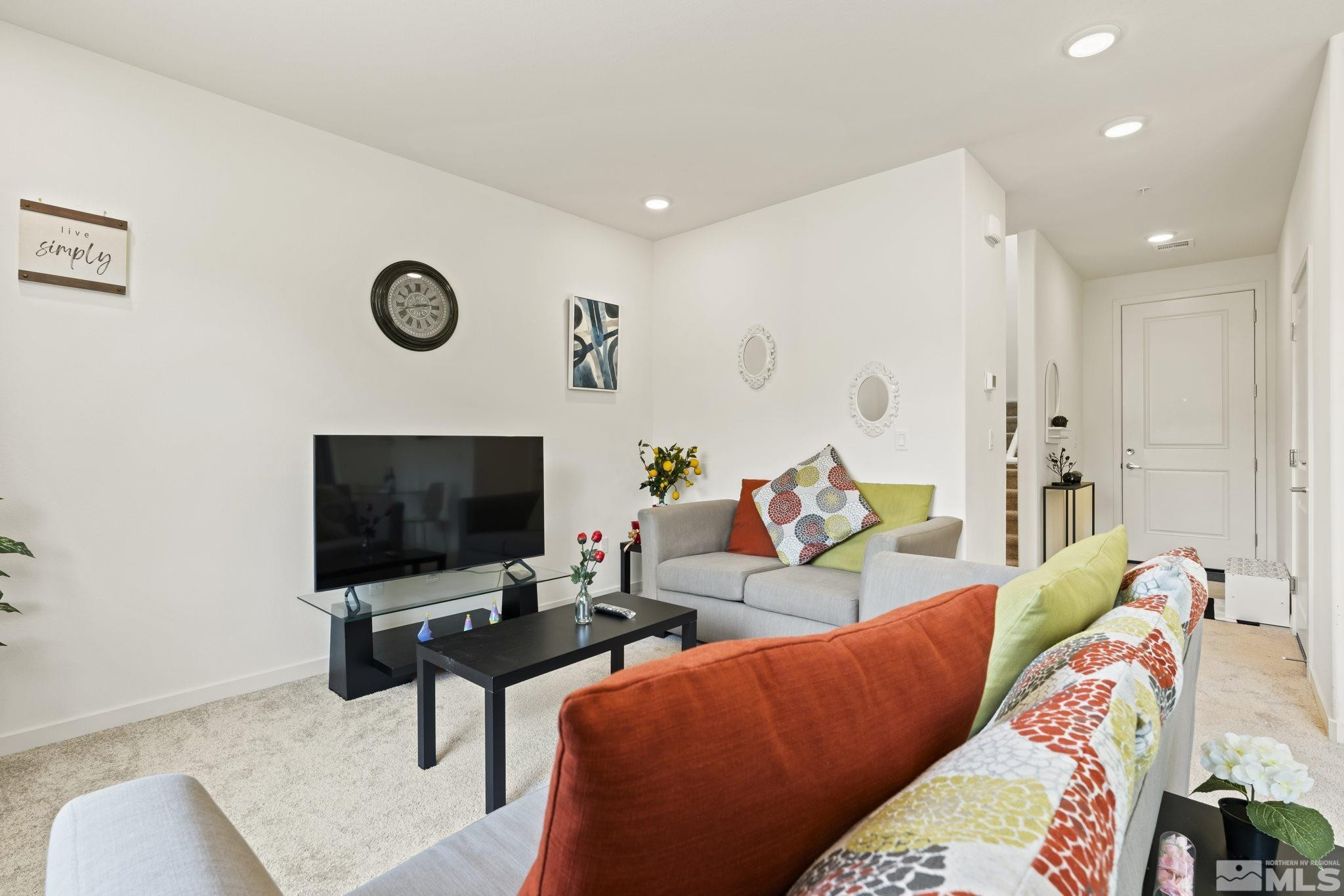4920 Little Rock Way Sun Valley, NV 89433 - Photo 1 of 37 a living room with furniture and a flat screen tv