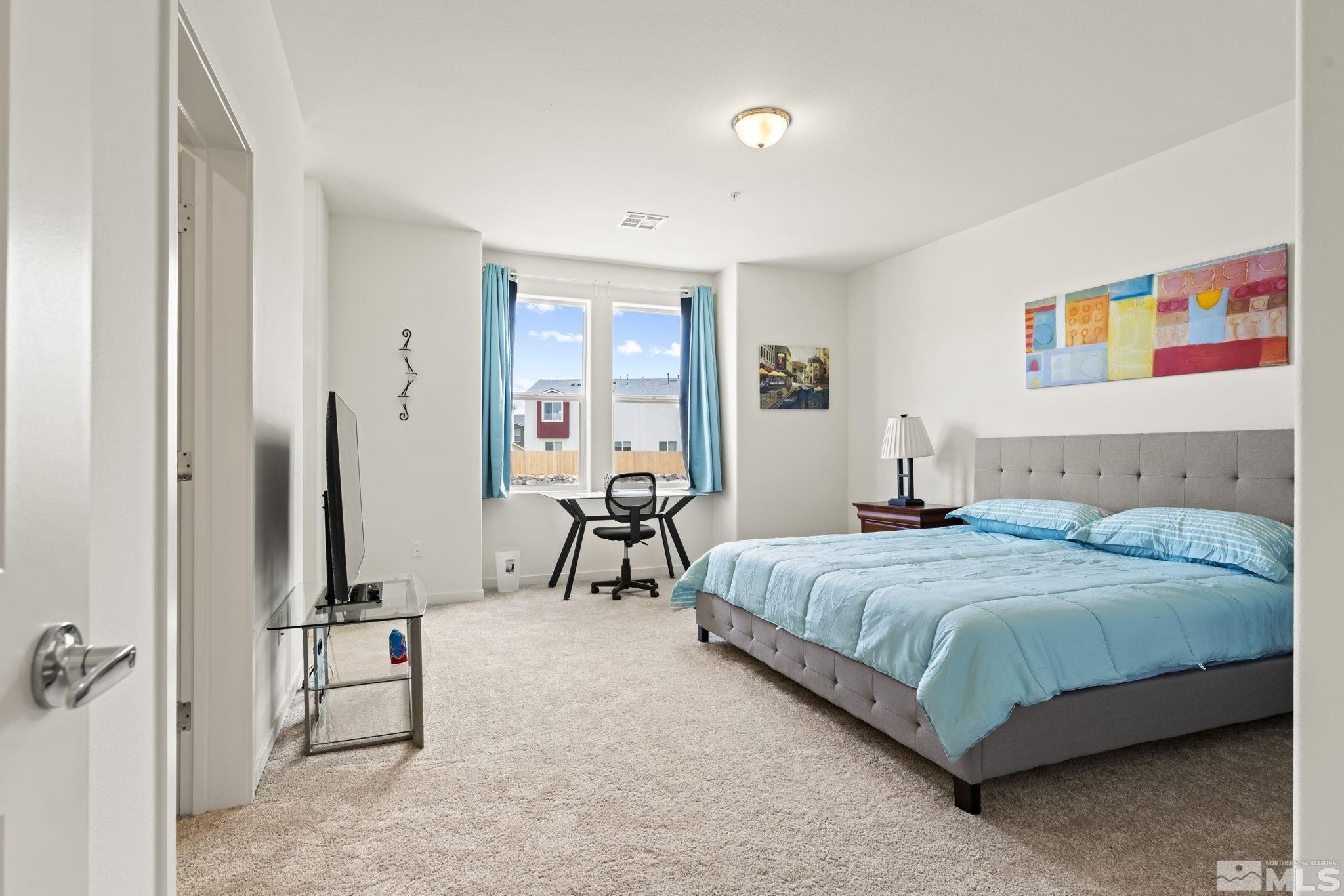 4920 Little Rock Way Sun Valley, NV 89433 - Photo 15 of 37 a bedroom with a bed and a table