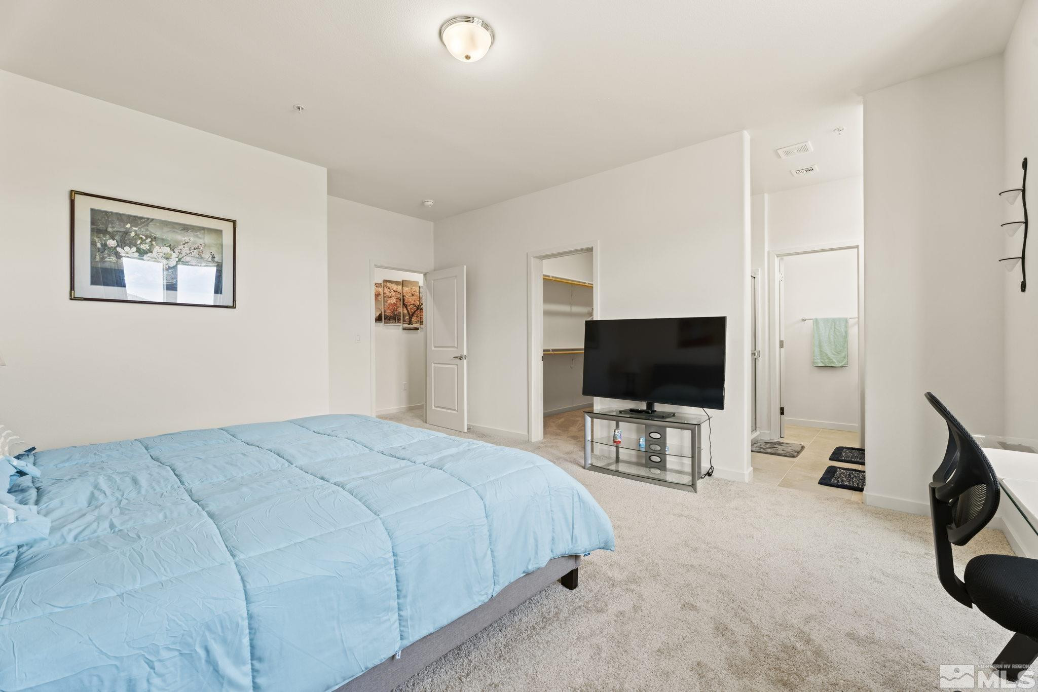 4920 Little Rock Way Sun Valley, NV 89433 - Photo 17 of 37 a bedroom with bed and tv