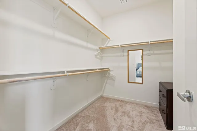 a bedroom with a bed a table and a window