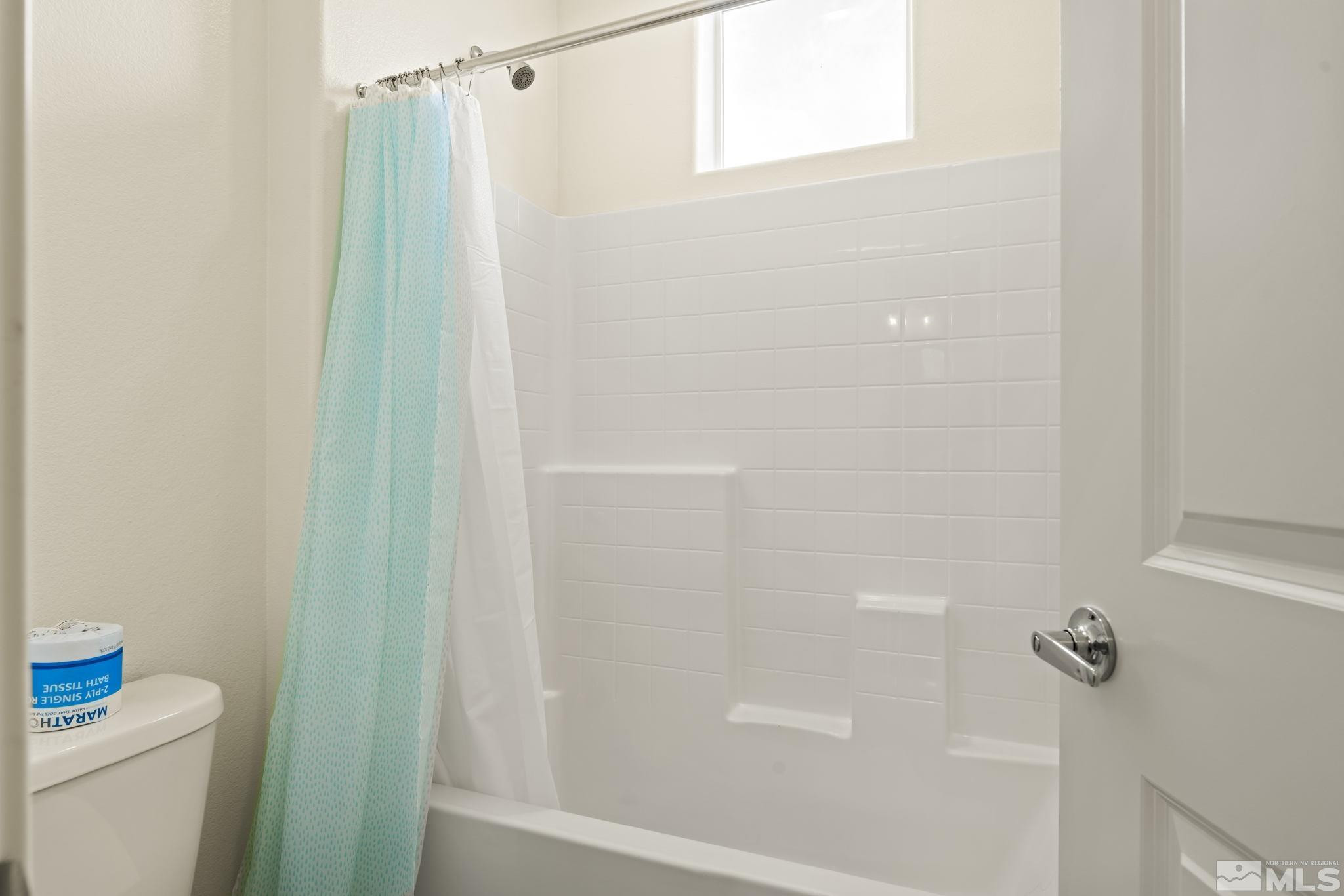 4920 Little Rock Way Sun Valley, NV 89433 - Photo 23 of 37 a bathroom with a shower and a toilet