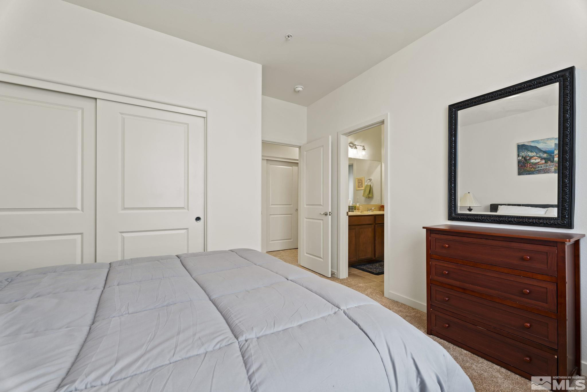 4920 Little Rock Way Sun Valley, NV 89433 - Photo 25 of 37 a bedroom with a bed and a dresser